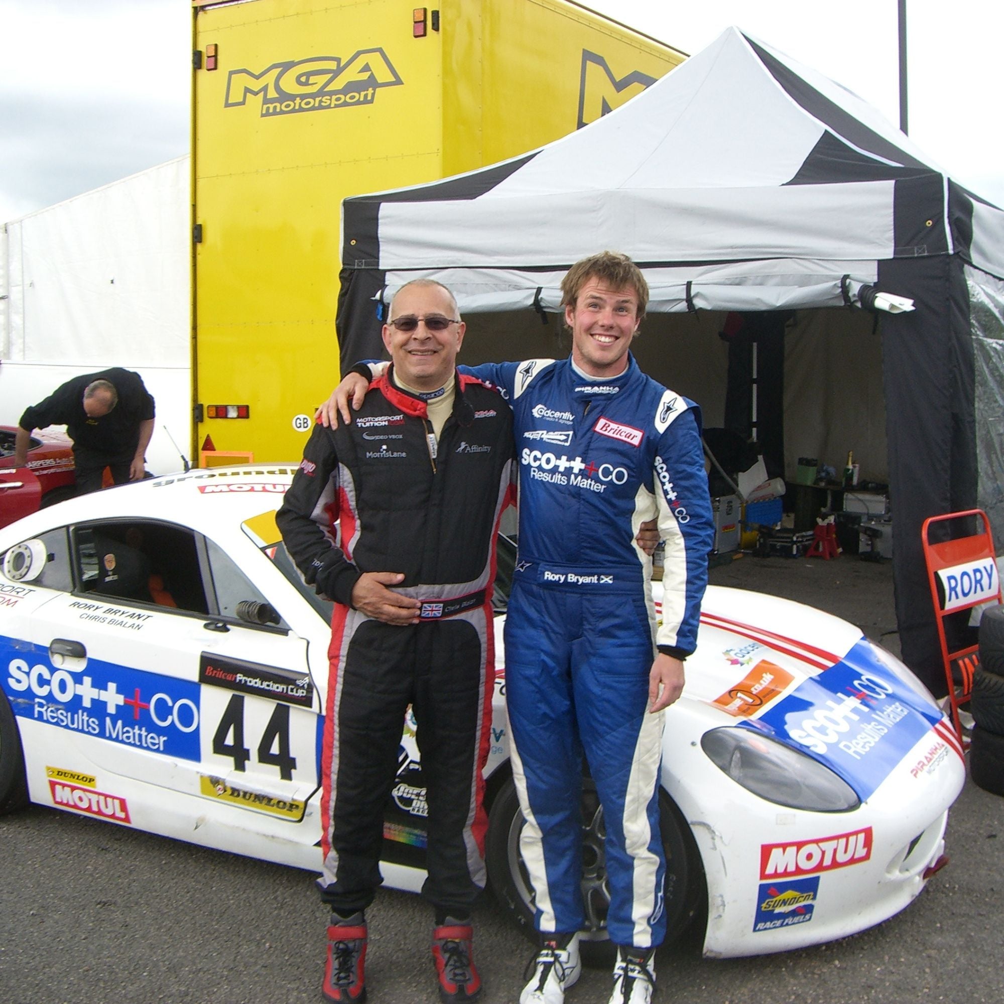 Chris Bialan with team in front of Piranha motorcar